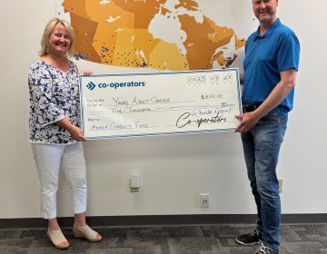 Rhonda Nugent (left) presents a cheque to Geoff Eaton, YACC executive director (right)