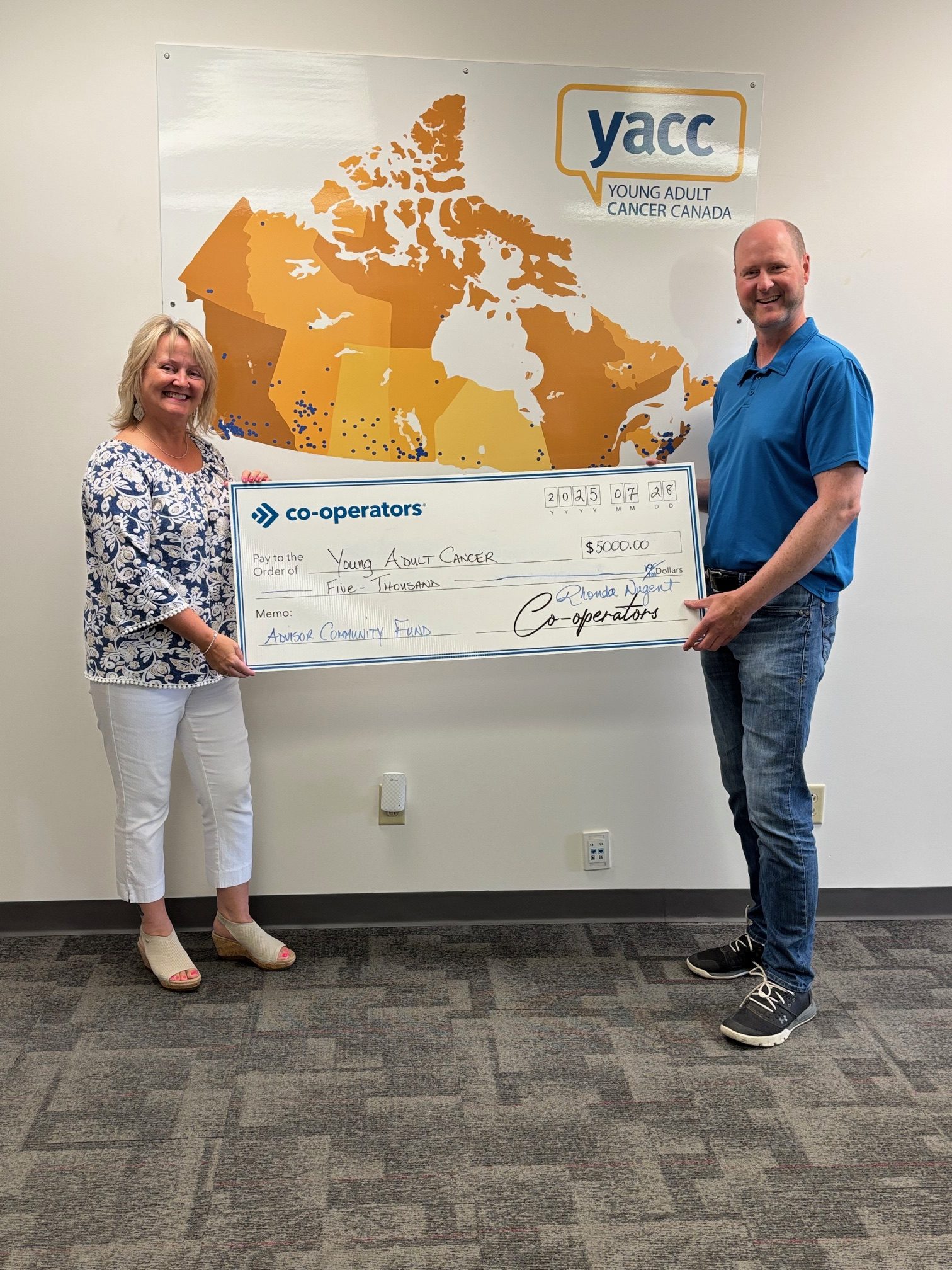 Rhonda Nugent (left) presents a cheque to Geoff Eaton, YACC executive director (right)