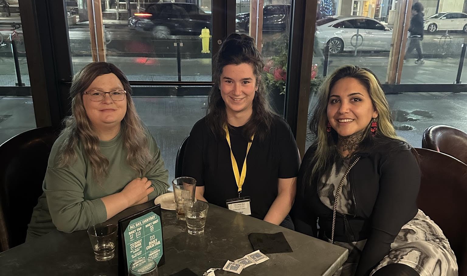 Angie, Stephanie, and Cheyenne at a restaurant table.